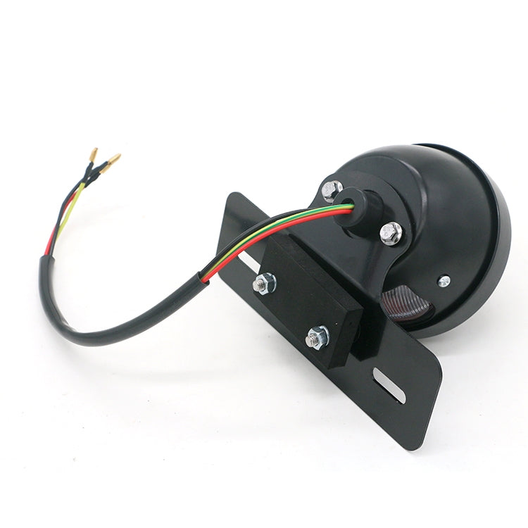 Rear view of black tail light with multicolor wire leads and metal mounting bracket
