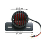 Round red LED tail light in black housing on plate with mounting slots and wires