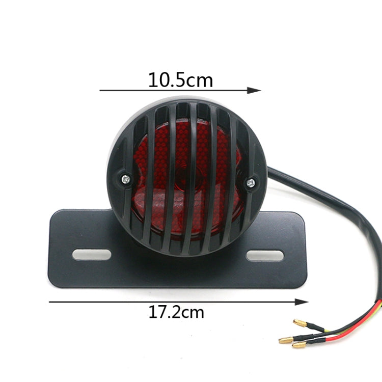 Round red LED tail light in black housing on plate with mounting slots and wires