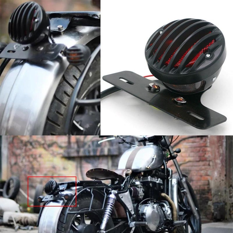 Retro tail light mounted on motorcycle rear, black housing with red LED stripes