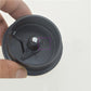 Round black ABS cable hole cover with hinged flap and cable opening, handheld close-up