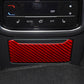 Red carbon-fiber charging port decorative trim on rear seat panel.