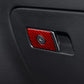 Red carbon-fiber glove box trim panel with small circular control cutout