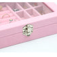Close-up of pink jewelry storage box front clasp with flannel lining and compartments