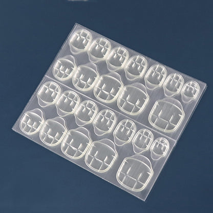 Double-sided nail glue film sheets with clear square nail stickers, neat grid of pieces