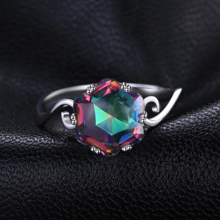 Multicolor faceted gemstone set in a silver-tone ring with curved decorative band elements