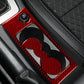 Red carbon-fiber cup holder insert with heart-shaped cutout mat in console