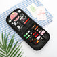 Black sewing kit case with colorful thread spools, scissors, needles, and pins laid out