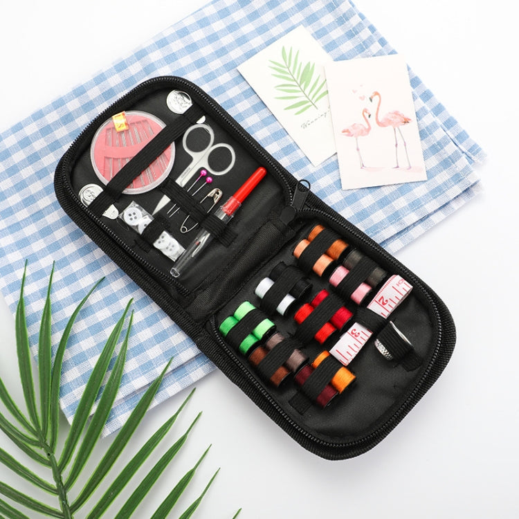 Black sewing kit case with colorful thread spools, scissors, needles, and pins laid out