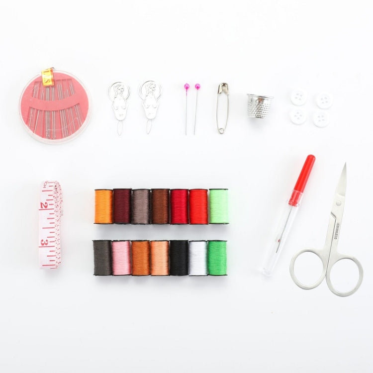 Sewing kit tools and thread spools laid out with needles, scissors, and measuring tape
