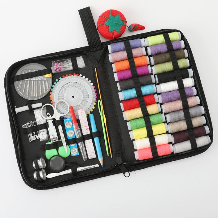Open black sewing kit organizer with thread spools, pincushion, and assorted tools
