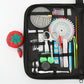 Open black sewing kit case with measuring tools, needles, scissors, and thread spools