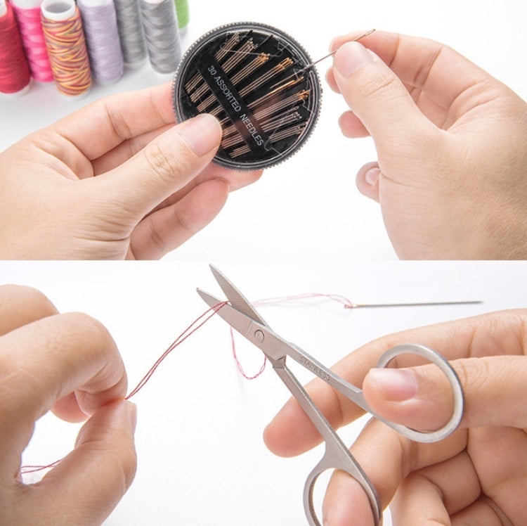 Close-up of hands holding a pin cushion, needles, and scissors for sewing