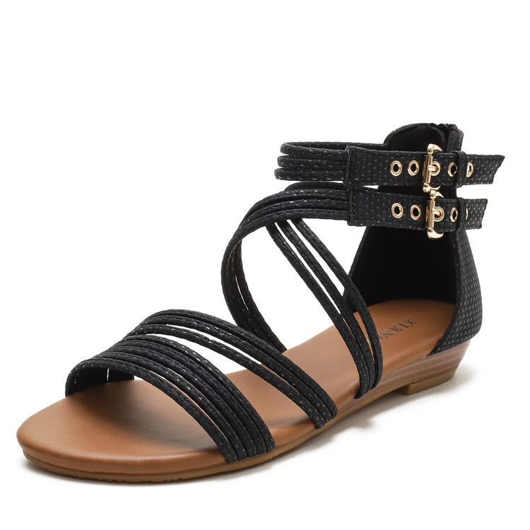 Women's black open-toe wedge sandals with Roman-style straps and ankle buckle closure.