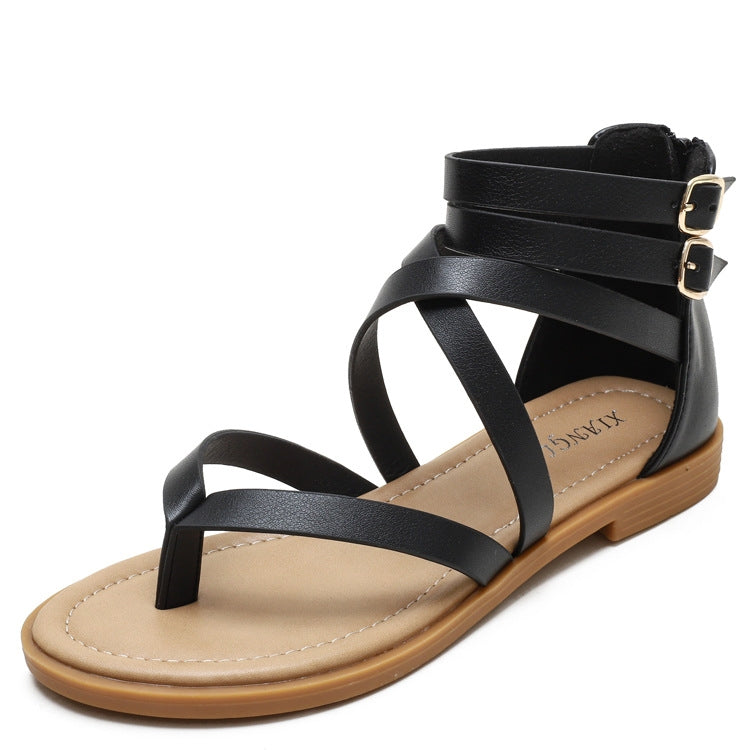 Black low-heel strappy sandals with crisscross straps and ankle buckle closure