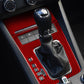 Red carbon-fiber gear shift panel trim sticker surrounding a leather shift knob and boot.