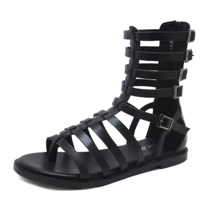 Black flat gladiator sandals with open toe, crisscross straps, and buckle details