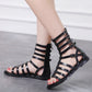Black open-toe flat sandals with ankle straps and square buckle closure details