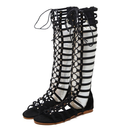 Black gladiator flat sandals with crisscross hollow straps and lace-up ankle