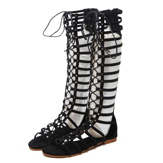 Black gladiator flat sandals with crisscross hollow straps and lace-up ankle