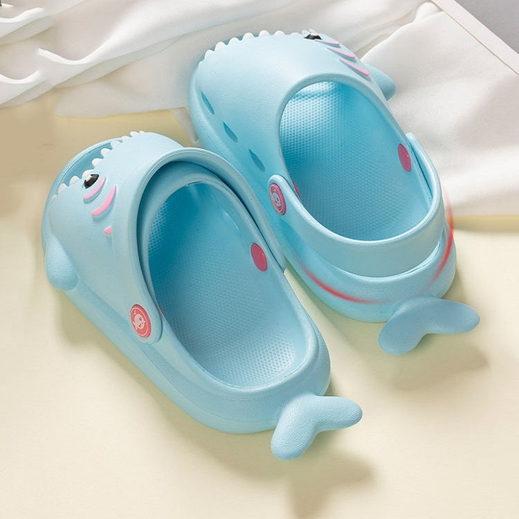 Light blue kids shark slippers with fin toe design and textured non-slip sole