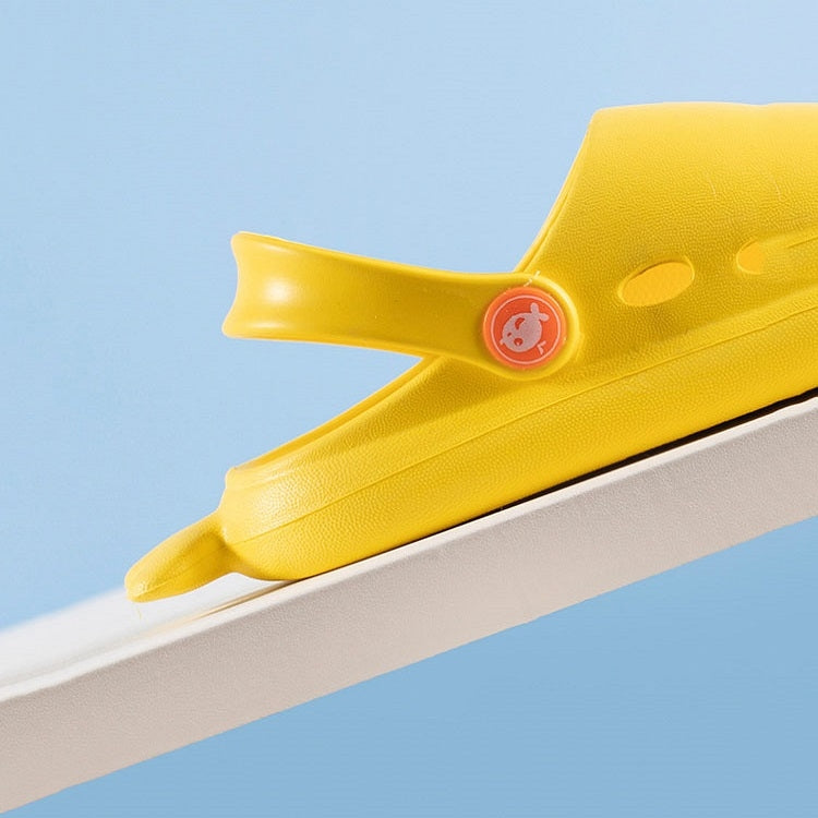 Yellow kids shark slippers with fin-style toe and grippy sole