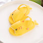 Yellow kids shark slippers, pair view with fin detail and stitched-tooth pattern