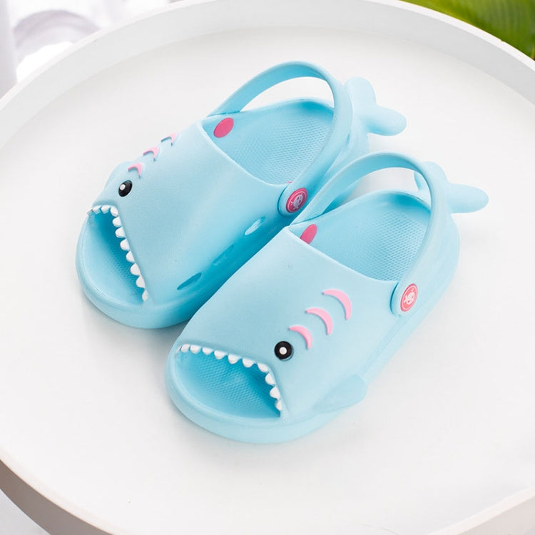 Light blue children's shark slippers with open toes, white teeth and heel straps