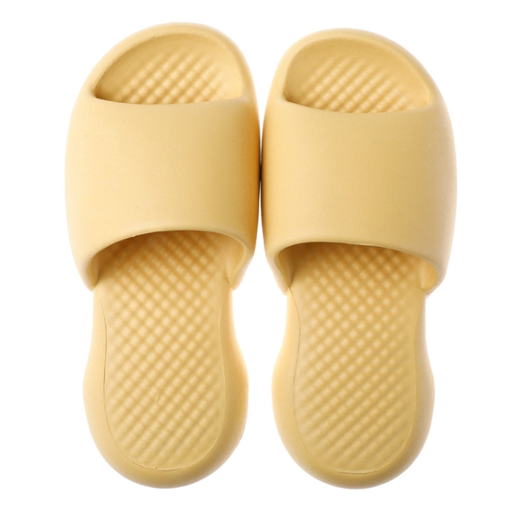 Pair of yellow plastic slide slippers with open toe and textured cushioned footbed