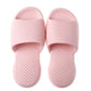 Pair of pink plastic open-toe slippers with cushioned textured grip footbed