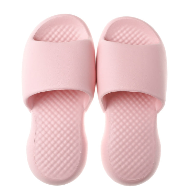 Pair of pink plastic open-toe slippers with cushioned textured grip footbed