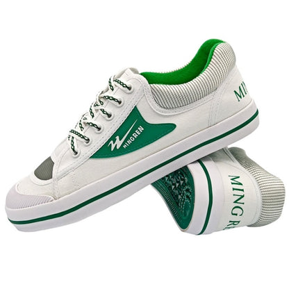 White canvas sneakers with green accents, lace-up design and striped collar