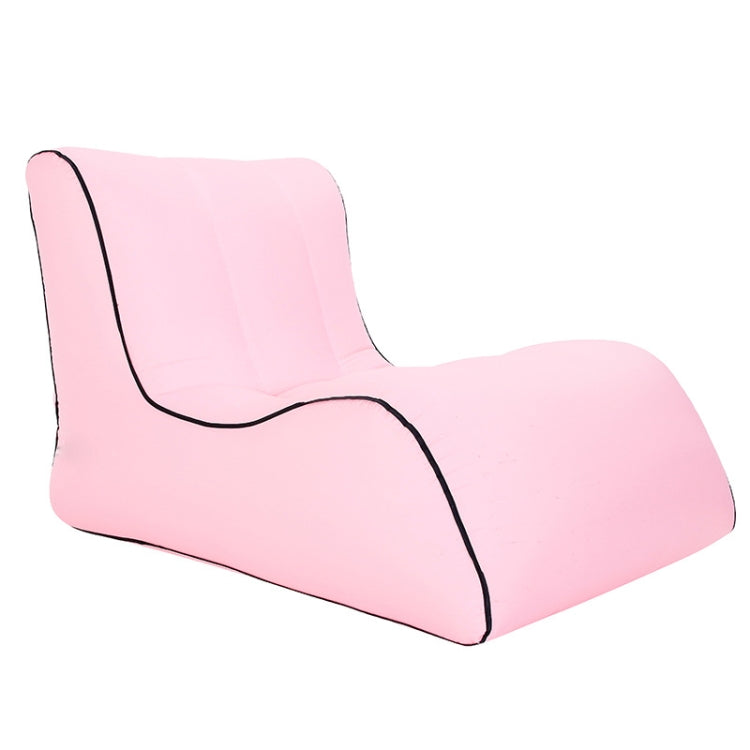 Single inflatable lounge sofa, pink with black piping and shaped backrest.