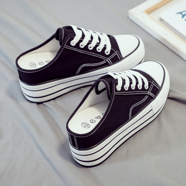 Black canvas platform mule sneakers, pair view with lace-up top and striped sole.