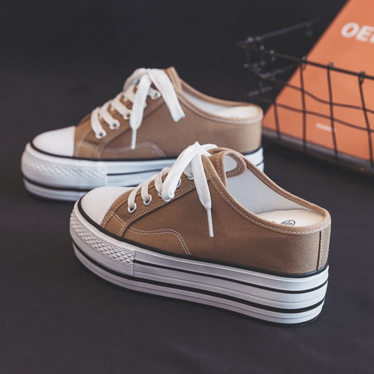 Women’s brown canvas platform sneakers with white laces and thick striped sole