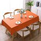 Orange waterproof disposable tablecloth covering a dining table