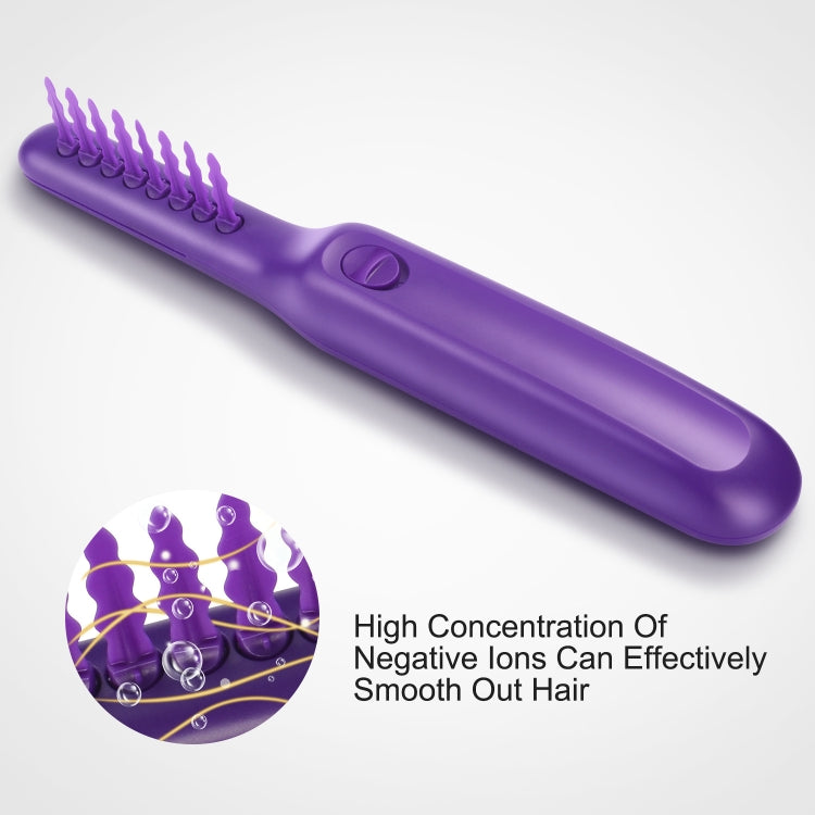 Purple electric rotating hair comb, close-up of handle and control button