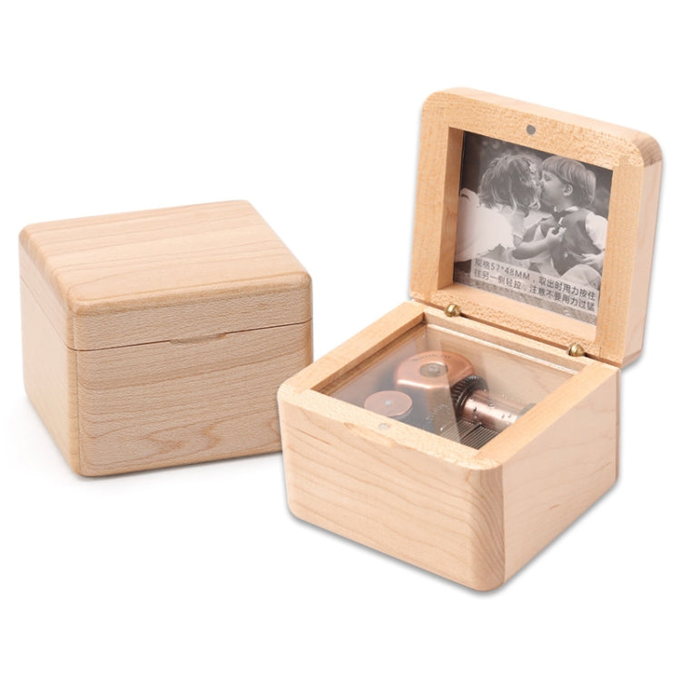 Light wood wooden music box with open photo frame and gold-toned movement inside