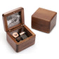 Dark wood music box with hinged lid, open metal music mechanism
