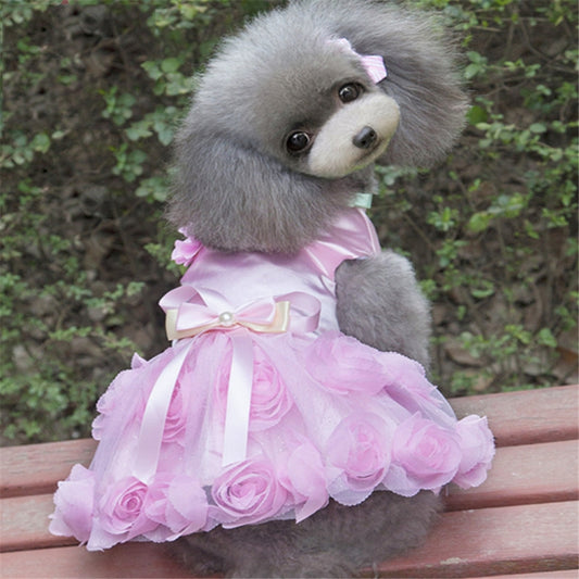 Pink dog dress with a satin bow and layered skirt decorated with fabric roses
