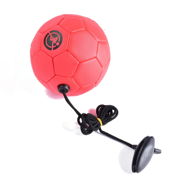 Red children training football with attached black rope