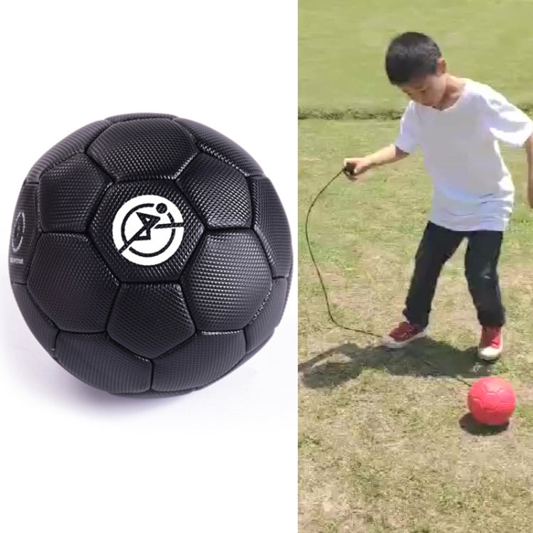Black children training football shown close-up