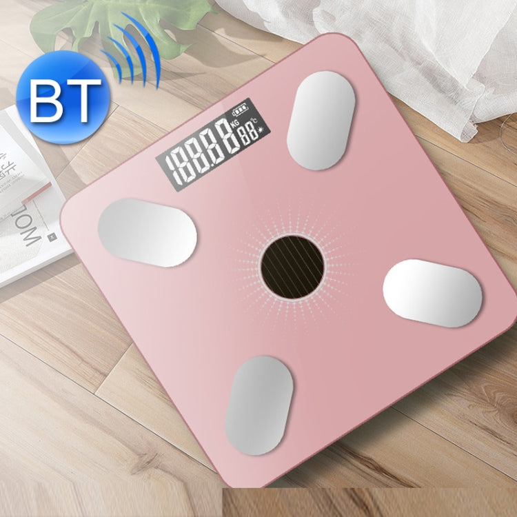 Pink smart Bluetooth weight scale on wood floor with bright digital screen