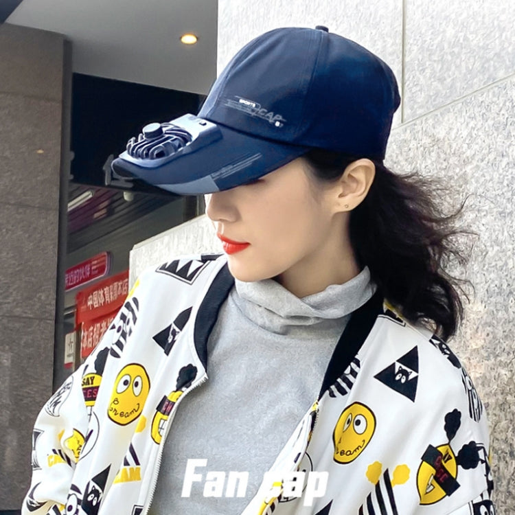 Navy fan sun cap worn by model with built-in vent housing at the side