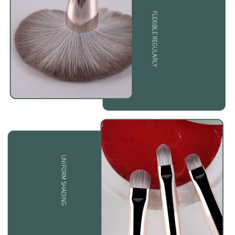 Fan makeup brush with soft gray bristles and silver ferrule, close-up with small brushes