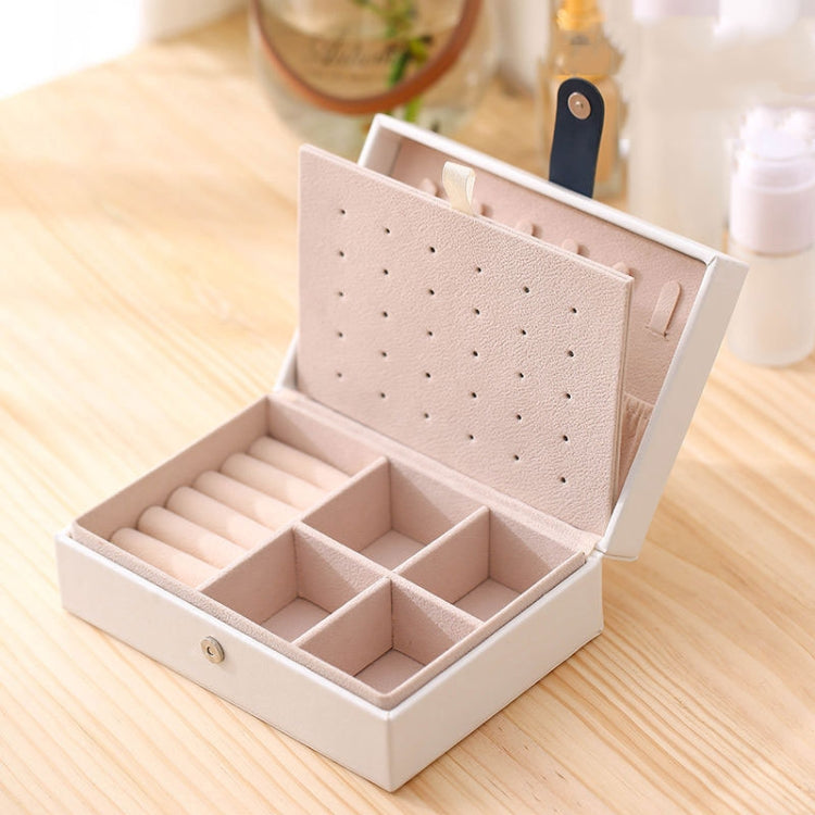 Small white jewelry storage box with hinged lid and divided compartments for rings and earrings