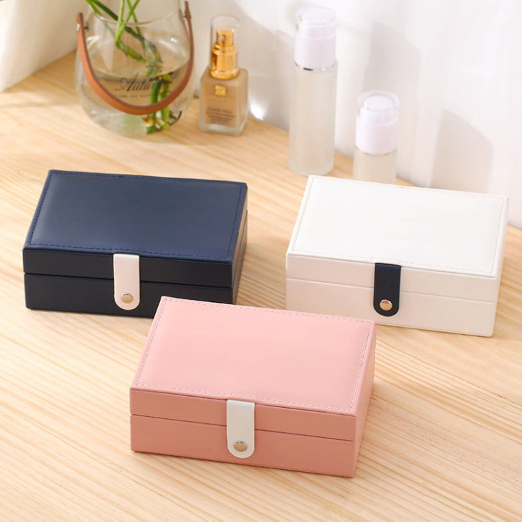 Set of three small jewelry storage boxes in navy, white, and pink with hinged lids