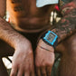 Blue digital sport watch worn on wrist with black rubber strap