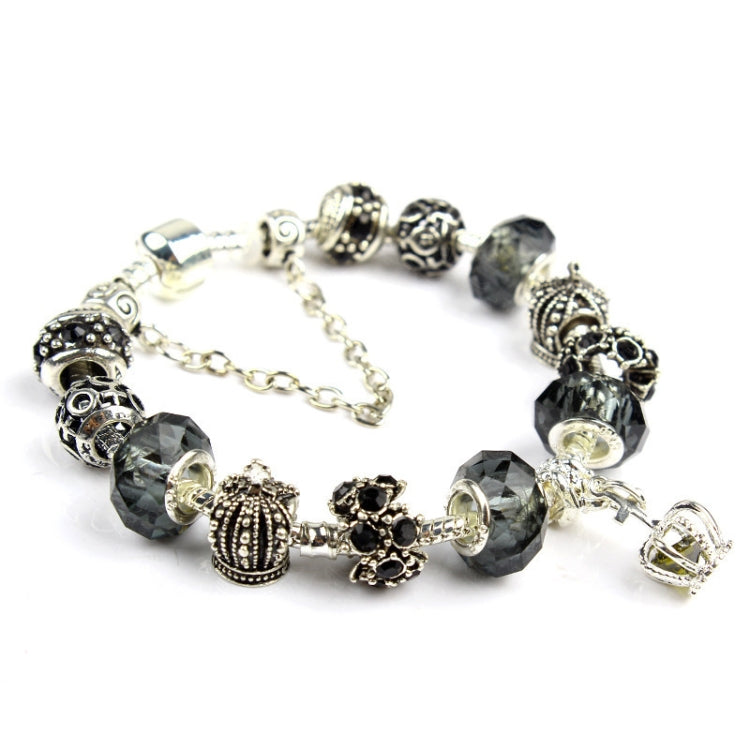 Charm bracelet with dark gray faceted crystal beads, silver-tone filigree charms, and chain