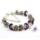 Purple crystal bead bracelet with ornate silver-tone spacers and rhinestone cluster charms